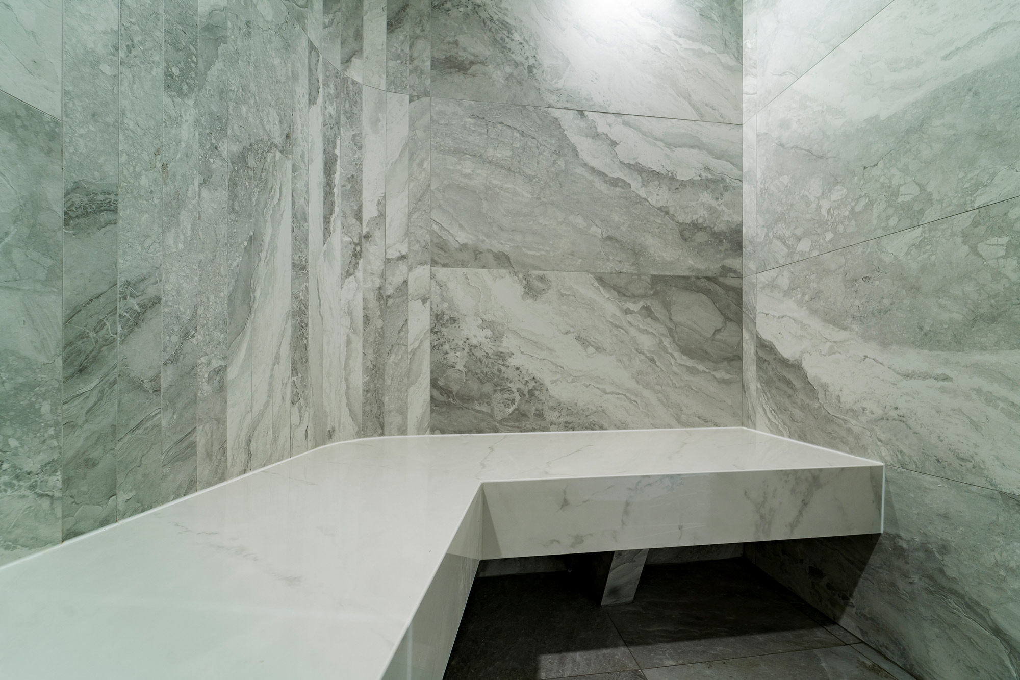 Image of sauna cape royal 1 in Dekton adds a new touch of elegance to the reception area of a luxury development in Singapore - Cosentino