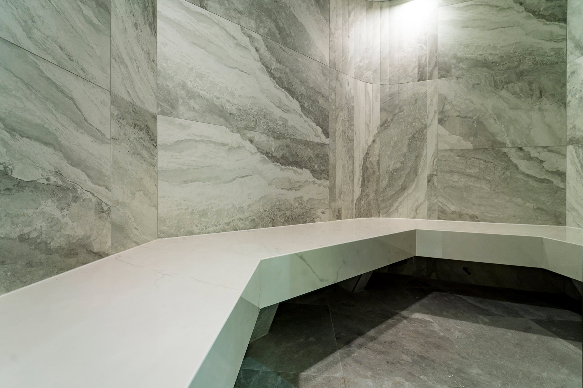 Image of sauna cape royal in Dekton adds a new touch of elegance to the reception area of a luxury development in Singapore - Cosentino